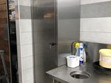a kitchen with a sink and a refrigerator in it
