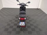 a motor scooter that is parked in a garage