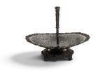 a silver plate with a handle on a stand