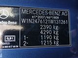 the back of a blue car with a mercedes benz sticker on it ' s side