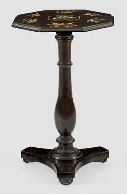 a black and gold table with a flower design on the top