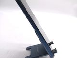 a cell phone on a stand on a white surface