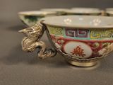 a bowl with a dragon handle and a bowl with a dragon handle on it