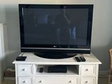 a television that is sitting on a stand in the living room