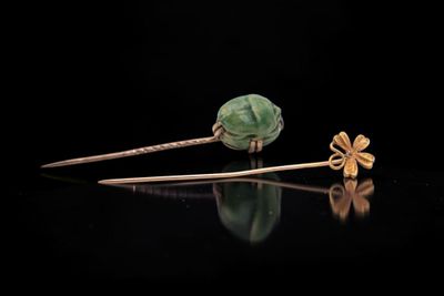 a pair of gold and jade flower hair pins