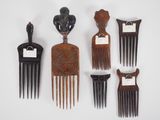 several wooden combs are lined up on a white surface