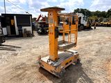 a yellow scissor sitting in the middle of a dirt lot