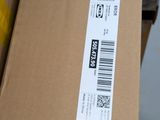 a cardboard box with a sticker on it sitting on the floor