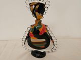 a figurine of a woman sitting on a table