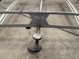 a metal object on the ground in a parking lot