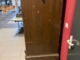 a wooden cabinet sitting on a pallet in the middle of a room