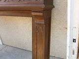 a wooden fireplace mantel sitting on the side of a building