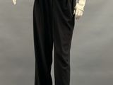 an image of a mannequin wearing a white shirt and black pants