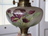 a glass vase with a purple flower painted on it