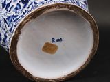 a blue and white vase sitting on a table