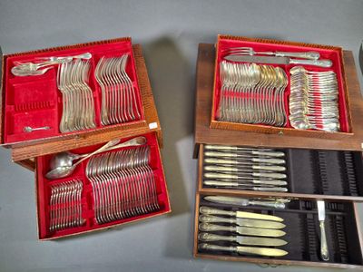 two wooden boxes with silverware in them on a table