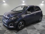 the small blue car is parked in a room with a checkered floor