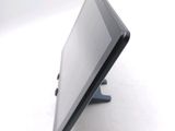 a tablet computer sitting on a stand on a white surface