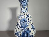 a blue and white vase sitting on a table