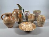 many different types of vases and bowls on the table