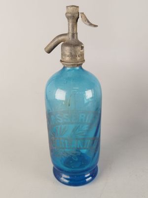 une bouteille en verre bleue munie d'un robinet en métal