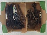 many pairs of scissors in a box on a table