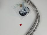 a close up of two hoses on a table with a red button