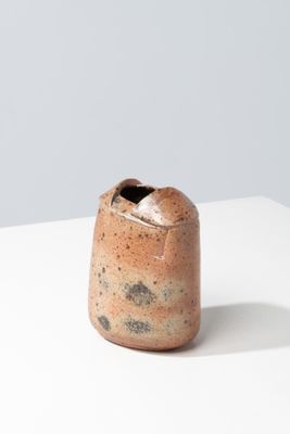 an image of a brown vase sitting on top of a white table