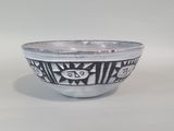a close up of a bowl on a table with a white background