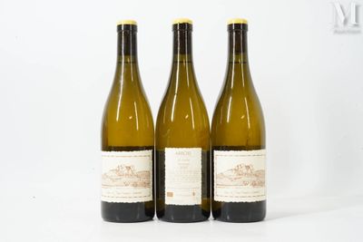 three bottles of wine sitting next to each other on a white surface