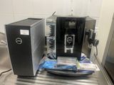 two coffee machines sitting on top of a stainless steel counter