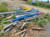 a pile of baseball bats laying on the side of the road