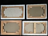 four pieces of cardboard are arranged in a row on a black surface