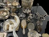 a lot of silver items on a black table