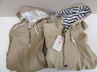 pair of jackets with hoods sitting on a white surface