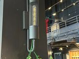 a plant that is hanging on the wall next to a clock