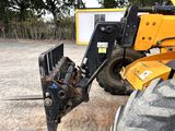 an image of a fork attachment attached to a construction vehicle