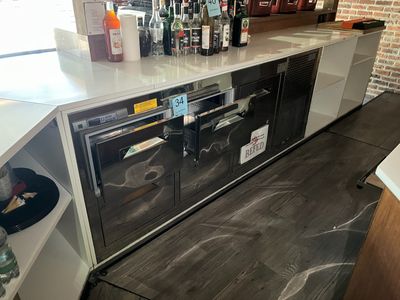 a counter that has a bunch of bottles on top of it