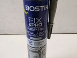 a close up of a bottle of fix and fix glue on a table