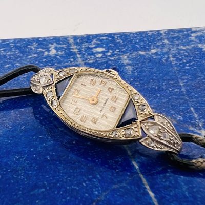 a watch that is sitting on top of a blue table