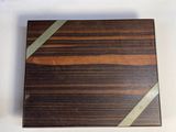 two pieces of wood sitting on top of a table next to each other