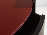 a close up of a black and red table with a heart shaped glass top