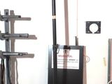 a speaker that is sitting on a tripod in a room