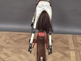 a toy horse that is standing on a wooden stand