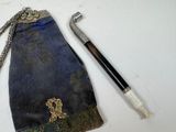 an image of a knife and a pouch with a cross on it