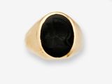 a close up of a gold ring with a black stone