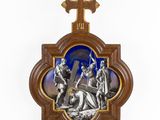 a wooden plaque with a cross and a picture of a man carrying a cross