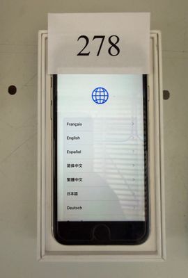 a phone that is sitting in a box with a sign on it