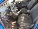 the interior of a blue car with a steering wheel and dashboard