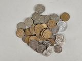 a pile of coins sitting on a white surface